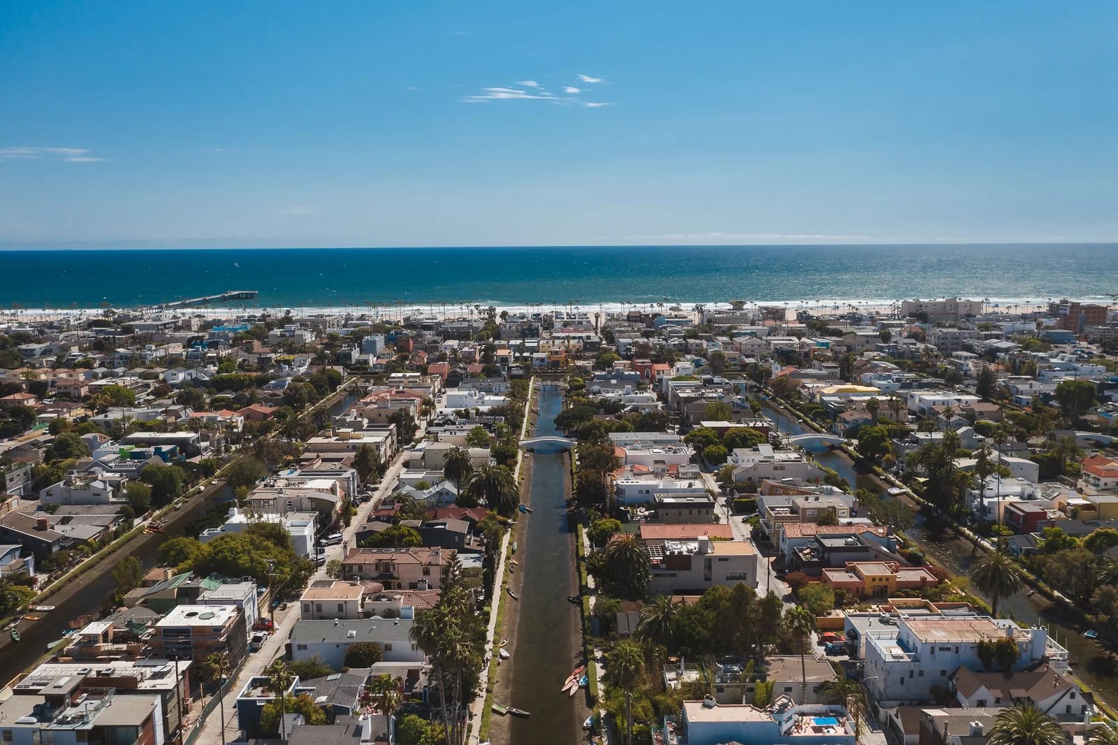 Stunning aerial view of a coastal cityscape with canals leading to the ocean horizon.